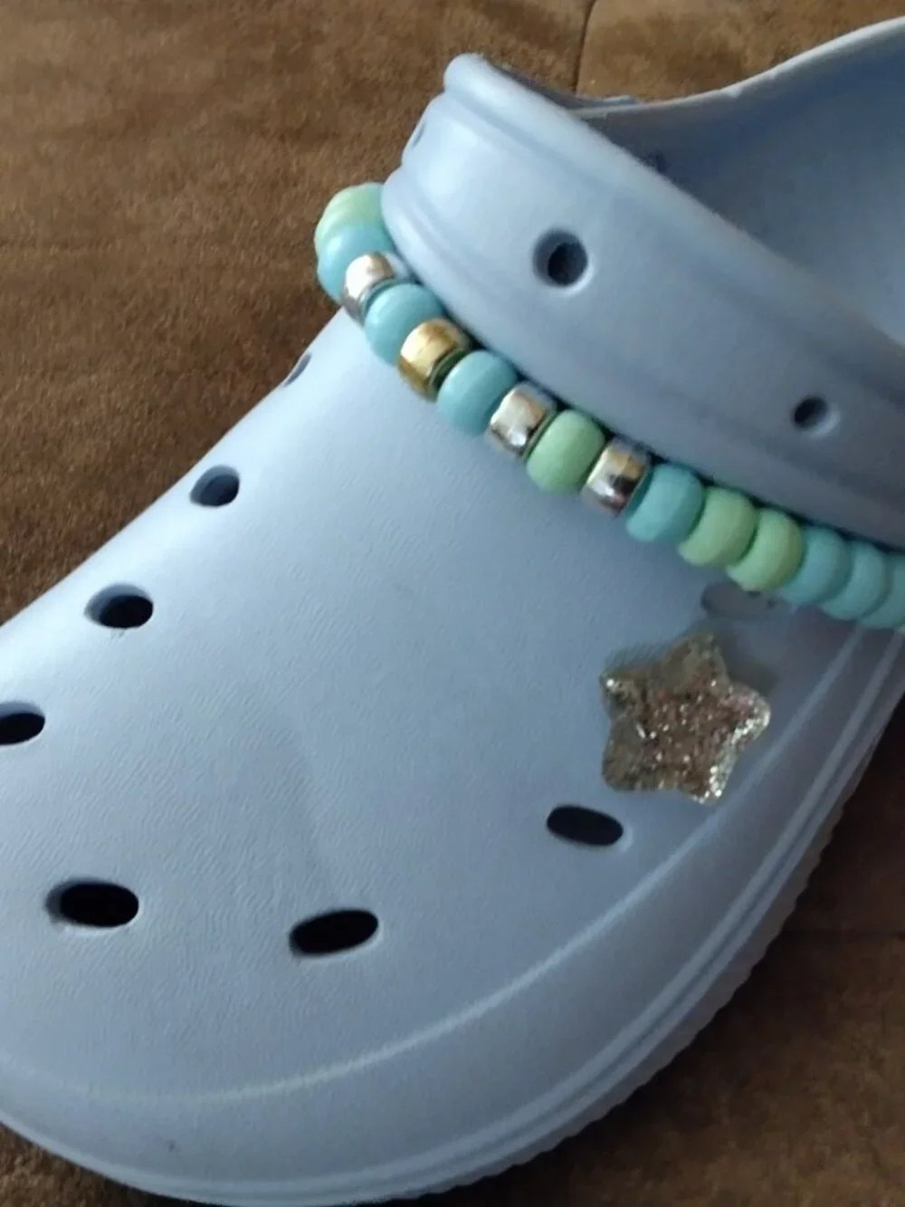 Embellished blue plastic shoes for kids with matching hair band.